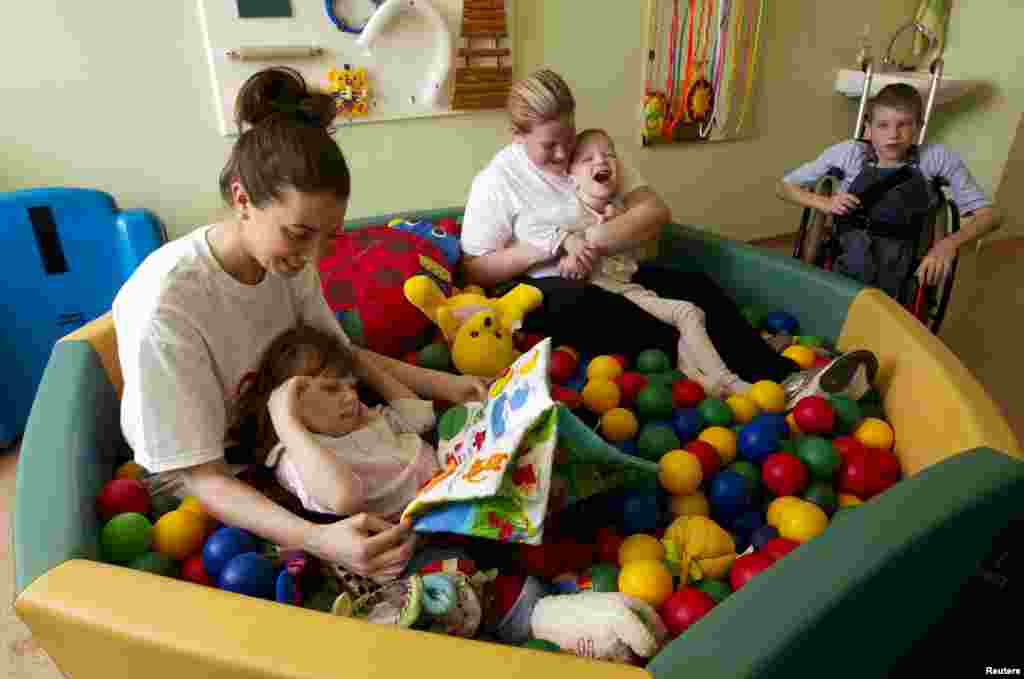 Laura Murphy and Loretta Gaughan from Ireland play with children.