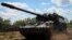 UKRAINE – Ukrainian servicemen ride a German self-propelled gun, Panzerhaubitze 2000, near the frontline, amid Russia's attack on Ukraine, in the Donbas region, July 12, 2022