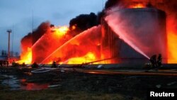 First responders work at a fuel-storage facility hit by cruise missiles in Lviv in western Ukraine on March 27.