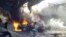 Vehicles burn following an explosion in the town of Darkush, in Syria's Idlib Province, on October 14.