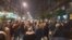 People in Belgrade on November 9 gather in support of Aida Corovic and Jelena Jacimovic, who were arrested for throwing eggs at a mural of Ratko Mladic.
