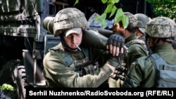 Українські військовослужбовці готують снаряди для стрільби з американської гаубиці M777 поблизу лінії фронту на Донеччині, 6 червня 2022 року