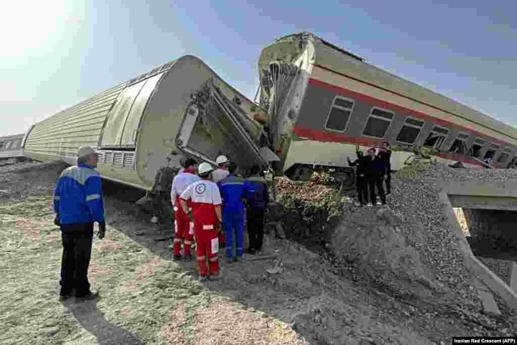 Rescuers work at the scene of a train derailment near the central Iranian city of Tabas on June 8.&nbsp;