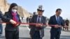 The chairman of the Kyrgyz Cabinet of Ministers, Akylbek Japarov (center), and Chinese Ambassador to Kyrgyzstan Du Dawen (left) open a bridge on November 11 to mark the completion of part of a highway project, just one of many infrastructure ventures in the region that receive support from Beijing. 