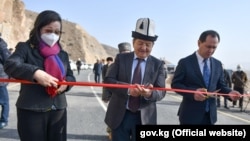 The chairman of the Kyrgyz Cabinet of Ministers, Akylbek Japarov (center), and Chinese Ambassador to Kyrgyzstan Du Dawen (left) open a bridge on November 11 to mark the completion of part of a highway project, just one of many infrastructure ventures in the region that receive support from Beijing. 