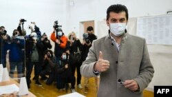 Kiril Petkov, the man tipped to become Bulgaria's next prime minister, gives a thumbs-up sign after casting his ballot in national elections on November 14. 
