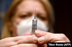 A nurse prepares a dose of the Sinopharm vaccine at an inoculation center in Budapest. (file photo)