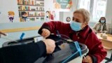 Kosovo - A women casts his vote in local elections in a school in Prishtina.14Nov2021