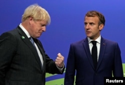 Прем’єр-міністр Великобританії Борис Джонсон і президент Франції Еммануель Макрон на кліматичній конференції ООН у Глазго, Шотландія. Великобританія, 1 листопада 2021 року