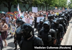 Police provide security as LGBT activist march in Chisinau in May 2019.