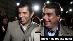 Kiril Petkov (left) and Asen Vasilev are all smiles after exit polls indicated their We Continue the Change movement had scored a victory.