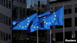 European Union flags fly at the European Commission headquarters in Brussels.