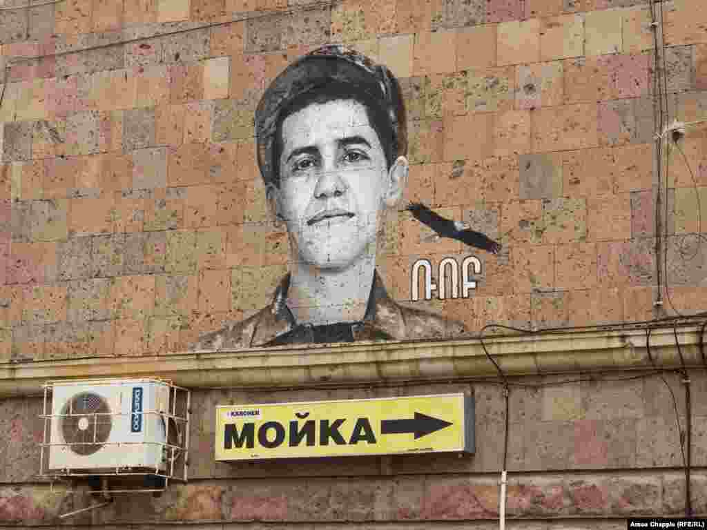 A portrait of a soldier named Rob on a building in the northern Armenian city of Gyumri.&nbsp; This image is one of scores of outdoor murals that have appeared across the country honoring soldiers who died in battle during the 2020 Azerbaijani offensive to retake Armenian-controlled regions in and around Nagorno-Karabakh.&nbsp;