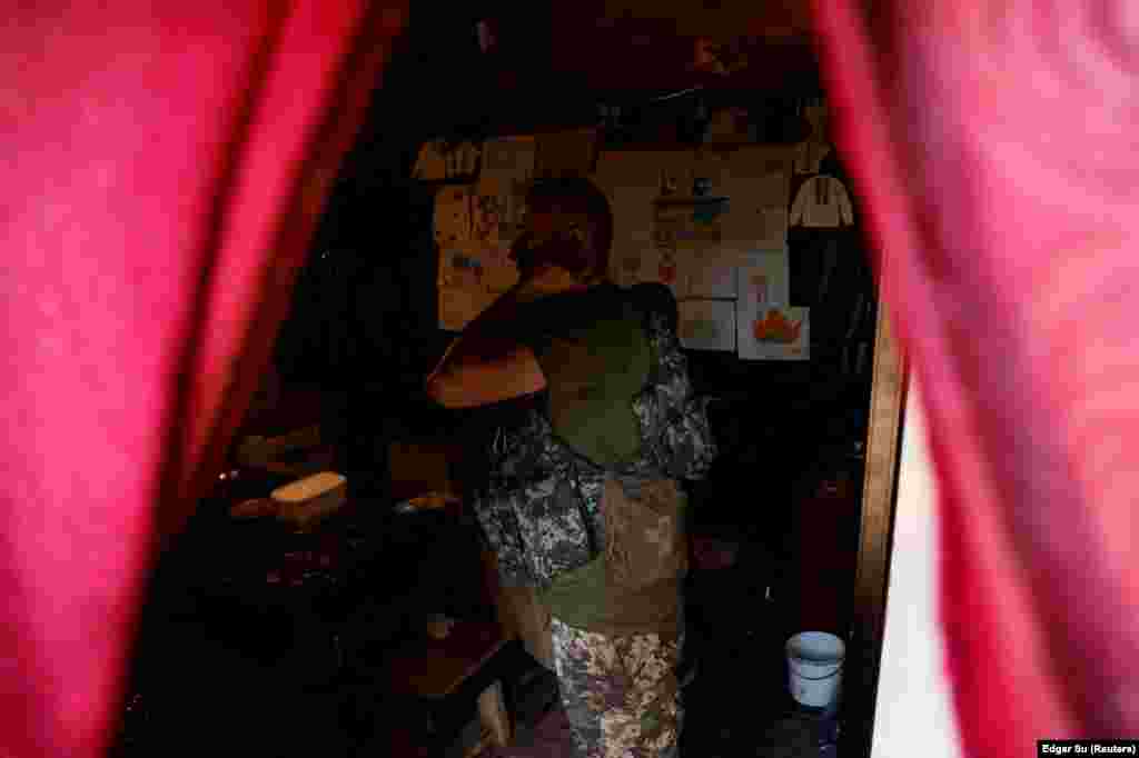 A Ukrainian soldier puts on his flak jacket in a trench on the front line. Presidential adviser Oleksiy Arestovych said on June 11 that nearly 10,000 Ukrainian soldiers have died since the beginning of the Russian invasion. The figure was quoted during an interview with The Washington Post. Arestovych estimated that &quot;200 to 300 die, no less&quot; per day but that the figures fluctuate.