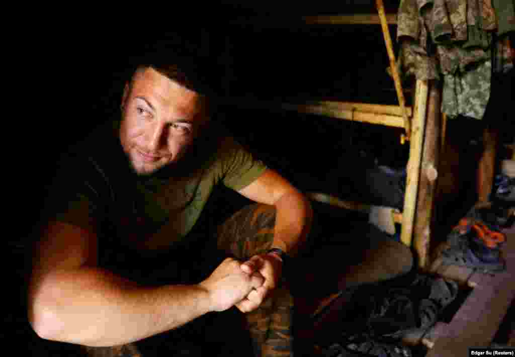 A Ukrainian soldier who calls himself Oleksandr Tchaikovskiy peers out of his trench.