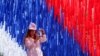 A woman takes a photo of an installation made in the colors of the Russian national flag at a Russia Day celebration in St. Petersburg on June 12.