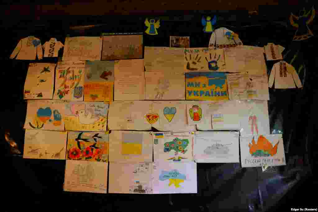 Drawings and letters sent by the children of Ukrainian soldiers serving in the trenches are displayed in a trench&#39;s mess area. &nbsp;