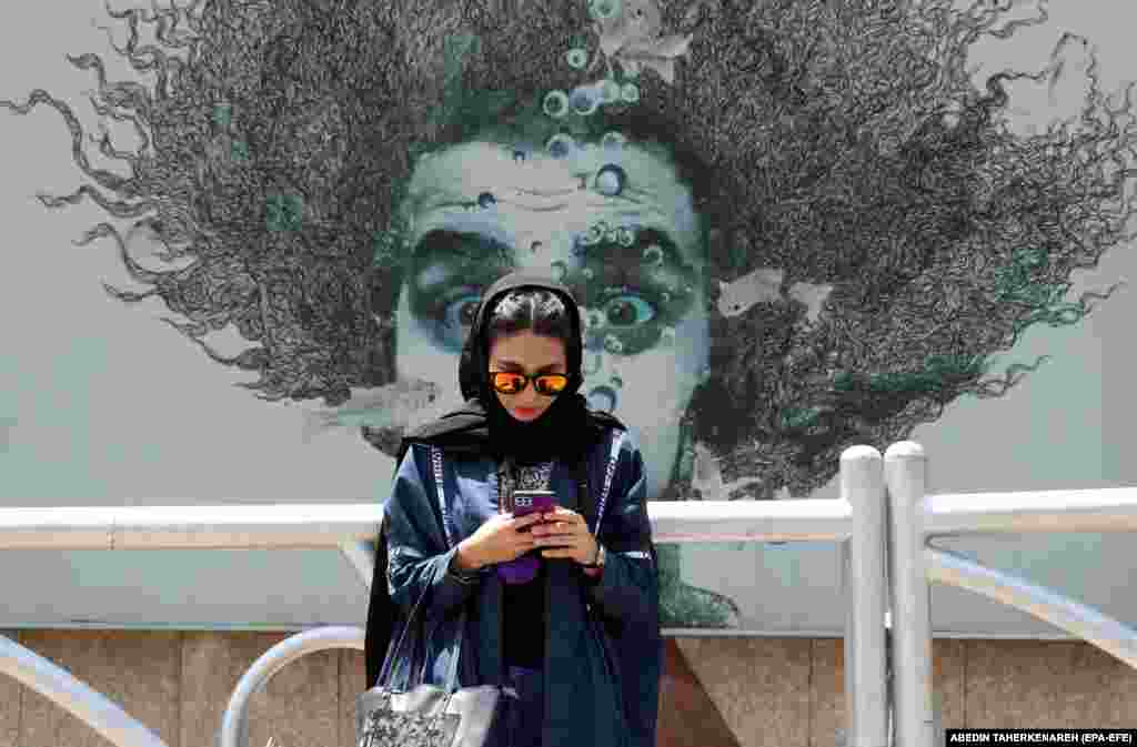 An Iranian girl checks her phone in Tehran on June 13.