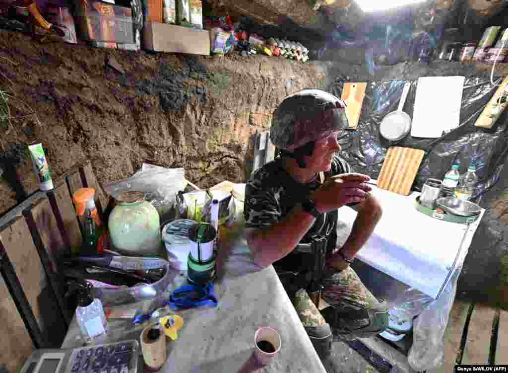 A Ukrainian soldier, Andriy, 54, takes a break in a trench along the front line near Mykolayiv. &nbsp;