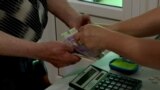 Detail of a hand holding some cash_hryvnia_Ukraine