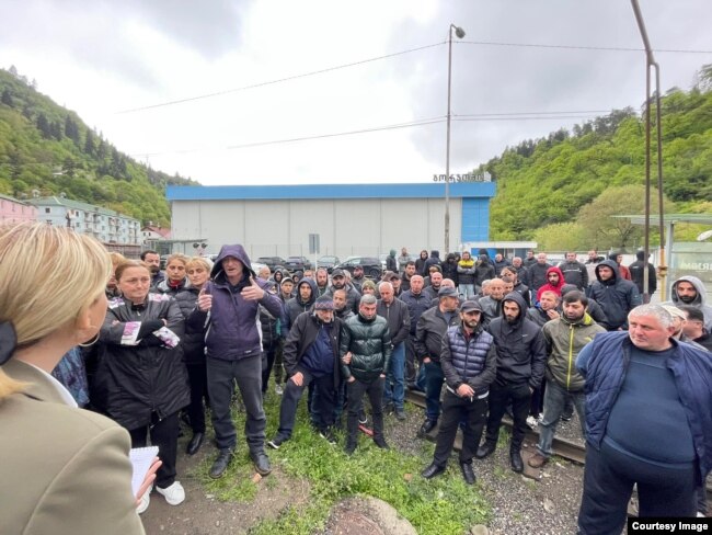 Workers gather outside of one of Borjomi’s two bottling plants on May 30.
