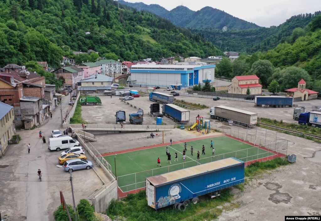 Striking workers and young locals play volleyball in front of one of Borjomi's two bottling factories on June 12.