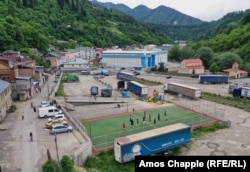Striking workers and young locals play volleyball in front of one of Borjomi's two bottling factories on June 12.