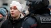 A pro-Navalny protester injured by riot police is detained in Moscow on January 23.