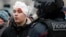 A pro-Navalny protester injured by riot police is detained in Moscow on January 23.