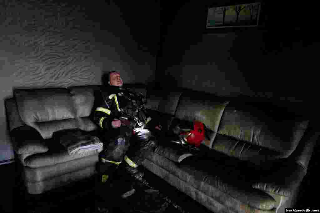 A firefighter takes a break during a fire at a house following a military strike in Kharkiv, Ukraine, on June 7.