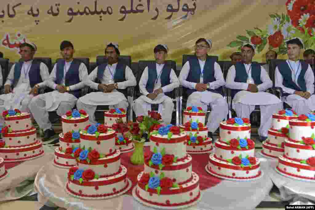 Grooms wait for the start a mass wedding ceremony in Kabul on June 13.