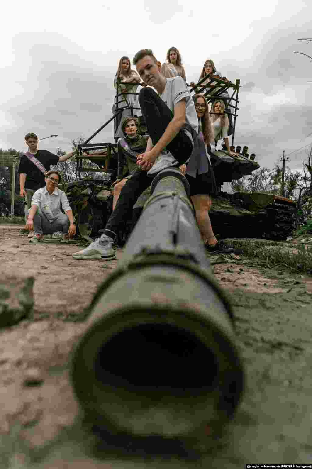 Chernihiv students pose for a high-school graduation photo on June 5 for Ukrainian photographer Stanislav Senyk, who spoke with RFE/RL about his project. Graduation Album On The Ruins is a series of photos of students, many in their sashes, captured in a city devastated by Russia&#39;s invasion.&nbsp; &quot;In 10 years, these students will have their own children, and they will be able to show them what the Russians did and, perhaps, they will feel the pain that their parents experienced.&quot;