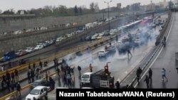 People protest against the government, blocking a highway in Tehran, Iran November 16, 2019. 