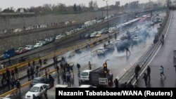 People protest against increased gas price, on a highway in Tehran, Iran November 16, 2019. 