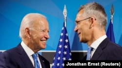 U.S. President Joe Biden (left) with NATO Secretary-General Jens Stoltenberg at the alliance's summit in Madrid on June 29. 