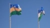 The flags of Uzbekistan (right) and Karakalpakstan (file photo)