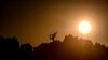 A person marks International Yoga Day by standing on the archeo-astronomical site that is the megalithic Kokino&nbsp;observatory in the northeast of North Macedonia on June 21.