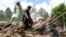 Afghans work to remove rubble from a house destroyed in the 6.10-magnitude earthquake that hit eastern Afghanistan on June 22. 
