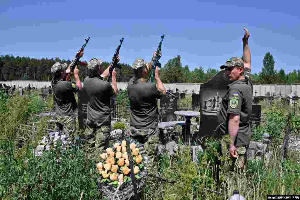 Soldiers fire a salvo in tribute to Ukrainian soldier Vladislav Andreev, killed in the Donetsk region, at his funeral in Bucha on June 20.