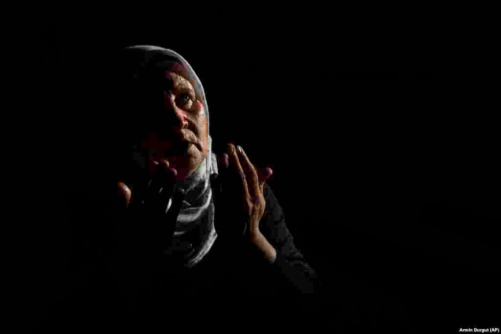 A Bosnian Muslim woman mourns beside a coffin containing the recently identified remains of a family member.