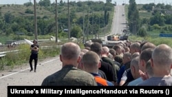 A view of the prisoner exchange on a road near Zaporizhzhya on June 29 in a photo provided by Ukraine's Military Intelligence.