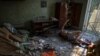 Local resident Volodymir, 66, lies wounded inside his flat in a building hit by a Russian military strike in Kramatorsk on July 7.