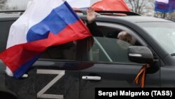 Участник акции в поддержку армии и президента РФ Владимира Путина во время автопробега