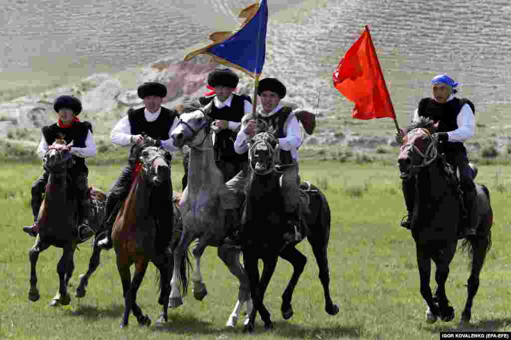 Kyrgyz horsemen display their colors as they race across the plains.