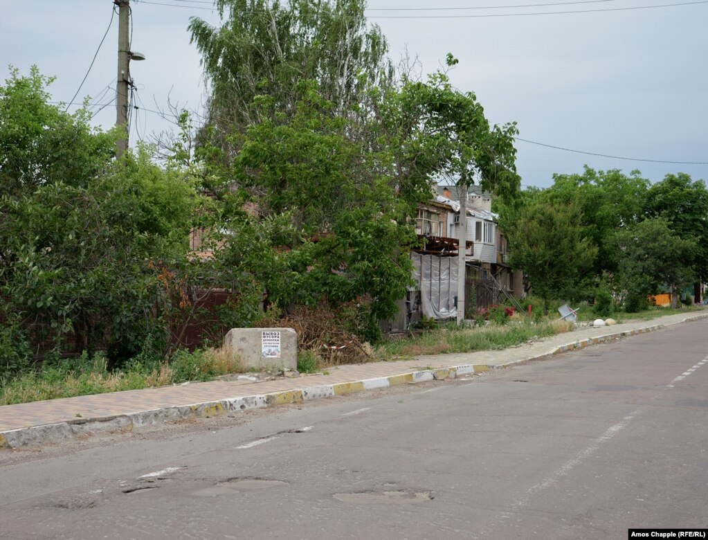 June 23. A poster has been placed on the concrete block advertising heavy rubbish removal.