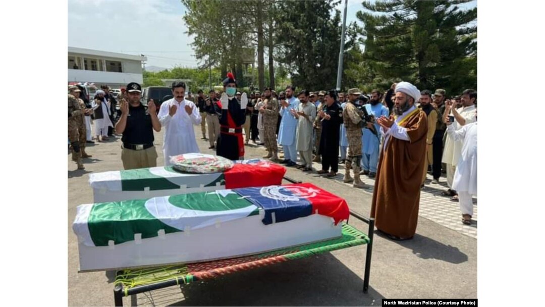 Men offer funeral prayers for two police officers killed in militant attacks in North Waziristan on June 28.