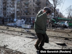 A heavily damaged street corner in Kyiv after an apparent missile explosion on March 13.