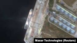 A satellite image shows what Maxar says is a ship being loaded with grain in Sevastopol on June 12.