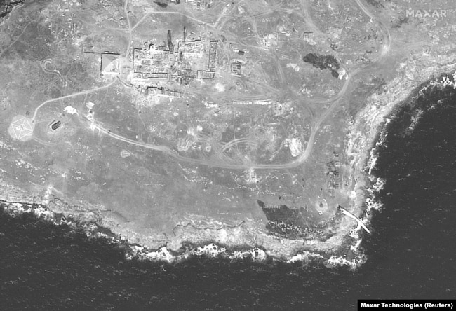 A satellite image shows the southern end of Snake Island and a destroyed tower (lower right), in a satellite image taken on June 21.