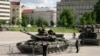 People look over a damaged Russian T-90A tank on display in a central Prague park on July 11.&nbsp;<br />
<br />
An exhibition of six Russian military vehicles damaged during the invasion of Ukraine will be officially opened in the evening by&nbsp;Zdenek Hrib, the mayor of&nbsp;Prague.